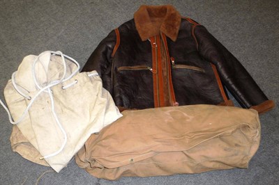 Lot 118 - A Brown Leather Flying Jacket, lined with sheepskin, with tan leather overstitched seams, zip...