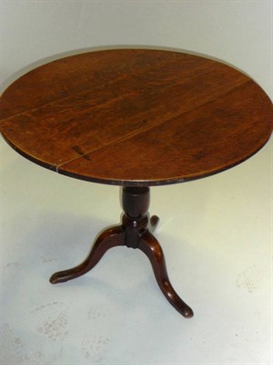 Lot 1417 - A George II Joined Oak Pedestal Table, mid 18th century, the circular flip top raised on a...