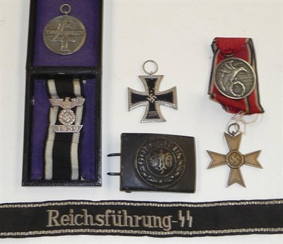 Lot 150 - A German Third Reich SS Long Service Medal, four years; a War Merit Cross, a copy of an Iron...