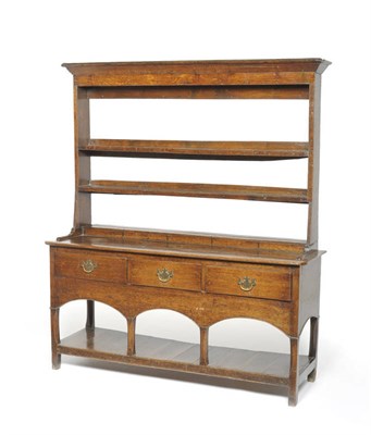 Lot 1421 - A George III Oak Cottage Dresser and Rack, late 18th century, the open rack with bold pediment...