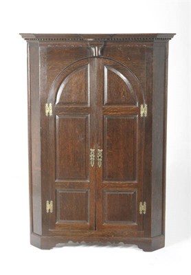 Lot 1423 - A George III Oak Hanging Corner Cupboard, Yorkshire, circa 1780, the deeply moulded cornice above a