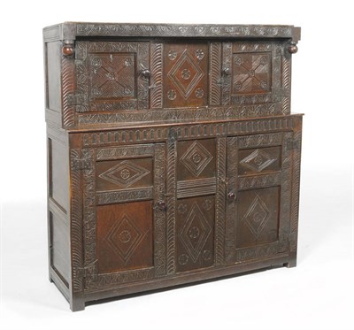 Lot 1424 - A Late 17th Century Joined Oak Press Cupboard, probably West Country, the lunette carved frieze...