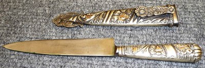 Lot 230 - An Argentinian Gaucho Knife, with Ju-Ca steel blade, the nickel grip and scabbard repousse and gilt