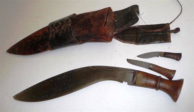 Lot 236 - A Second World War Kukri, with double fullered steel blade, wood grip with brass butt plate,...