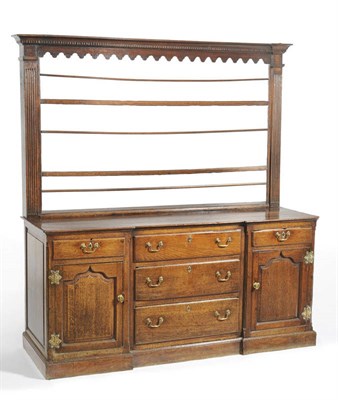 Lot 1427 - A George III Oak Enclosed Dresser and Rack, the moulded dentil cornice above three open shelves and