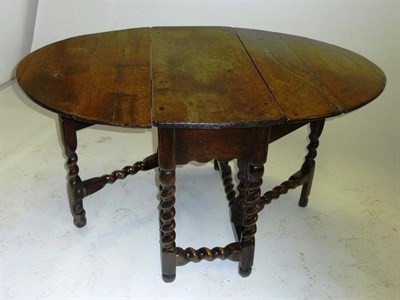 Lot 1432 - A Late 17th Century Oak Six-Seat Gateleg Table, the rectangular top with two hinged leaves to...