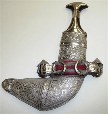 Lot 289 - A 20th Century Omani Khanjar, the curved steel blade with raised medial ridge, with silver...