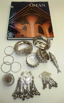 Lot 322 - A Collection of Omani Silver and White Metal Jewellery, comprising a pair of stiff hinged...