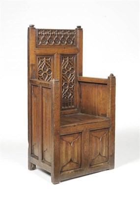 Lot 1436 - A Joined Oak Armchair, the rectangular back carved with Gothic tracery, above flat arms and boarded