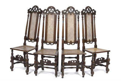 Lot 1437 - A Set of Four Early 18th Century Caned Beechwood Chairs, the narrow backs with arched pierced...