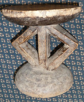 Lot 343 - A Dogon, Mali Wood Headrest, with dished circular pillow on a pierced diamond section pillar...