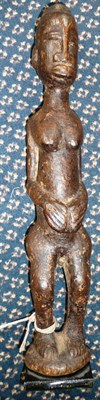 Lot 349 - An African Carved Wood Female Fertility Figure, possibly Baule, Ivory Coast,the whole covered...