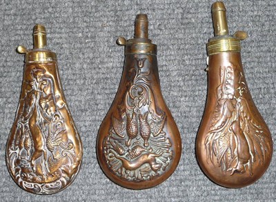 Lot 376 - Three Copper Powder Flasks, each embossed with hanging game, with brass charger and external spring