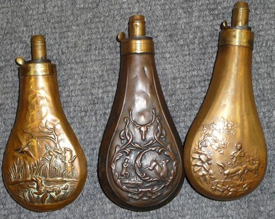 Lot 377 - Three Copper Powder Flasks, each embossed with shooting scenes, with brass charger and external...