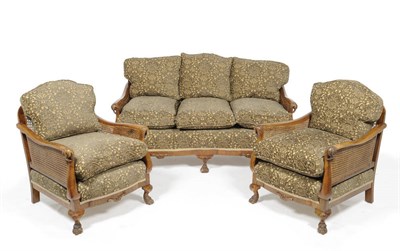 Lot 1459 - A Walnut Framed Bergere Settee, early 20th century, upholstered in brown and yellow dralon, the...