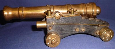 Lot 83 - A Brass Model of a Signal Cannon, with 24cm barrel, on an oak carriage with brass wheels, with...