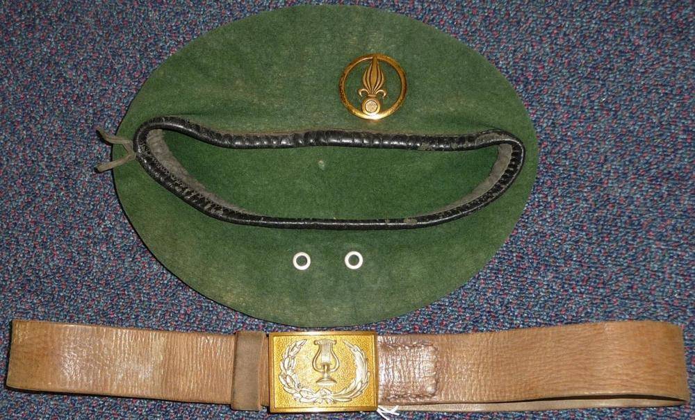 Lot 90 - A  French Foreign Legion Green Beret, set with a gilt brass badge to a non-Cavalerie unit; a...