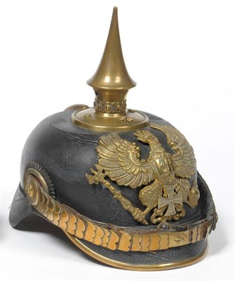 Lot 125 - A Prussian Reserve Officer's Pickelhaube, with leather skull, brass helmet plate as a Prussian...