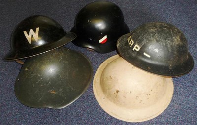 Lot 129 - Five Helmets:- Three Second World War Civil Defence Brodie Helmets; an East German Model...