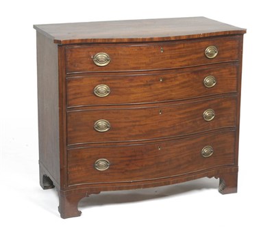 Lot 1474 - A George III Mahogany Serpentine Front Chest of Drawers, circa 1800, the shaped top above four...