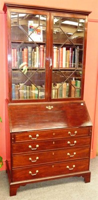 Lot 1479 - A Late George III Mahogany Bureau Bookcase, circa 1800, the moulded pediment above two astragal...