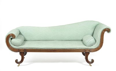 Lot 1486 - A Regency Mahogany Framed Chaise Longue, early 19th century, upholstered in close nailed bottle...