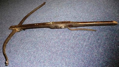 Lot 258 - A 17th Century Crossbow, the 78cm iron bow with folded dog-nose nocks, fruitwood stock with...