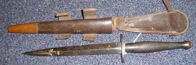 Lot 284 - A Second World War Second Pattern Commando Knife, with 17.5cm hand forged blued steel blade,...