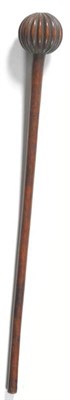 Lot 306 - A 19th Century Zulu Knobkerrie, of rich chestnut colour, with a deeply fluted globular head and...