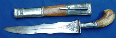 Lot 329 - A Malayan Bade Bade, with foliate engraved double wavy edge steel blade, white metal crossguard and