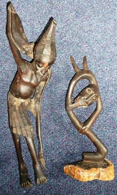 Lot 339 - Two Makonde, East Africa Ebony Abstract Figures, one as a burdened old man touching earth for...