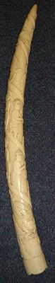 Lot 361 - An Early 20th Century Loango Ivory Tusk, carved with a spiral of figures including a man with a...