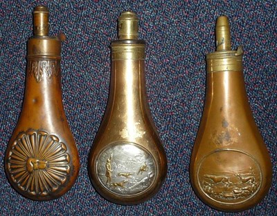 Lot 395 - Three Copper Powder Flasks: one embossed with a rosette centred by the head of a gundog, the...