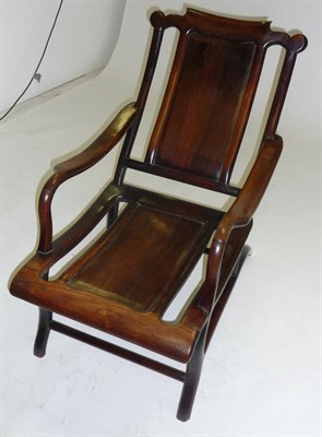 Lot 1505 - A Chinese Hardwood Planter Armchair, early 20th century, the wavy shaped top rail above a panel...