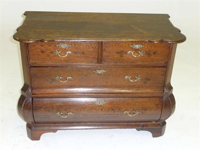 Lot 1513 - A Dutch Oak Bombé Chest, the moulded top above two short and two long drawers with later brass...