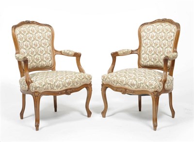 Lot 1519 - A Pair of Walnut Framed Fauteuils, late 19th century, upholstered in cream and floral damask,...