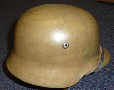 Lot 85 - A Second World War German M35 Helmet, in olive green, the inner brim stamped 4616 SE64, with...