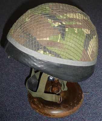Lot 92 - A British Paratrooper's Helmet, with camouflage and netting cover, webbing strap with leather...