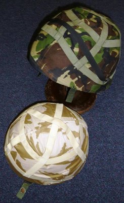 Lot 93 - Two British Kevlar Helmets, with jungle and desert camouflage covers, webbing straps with...