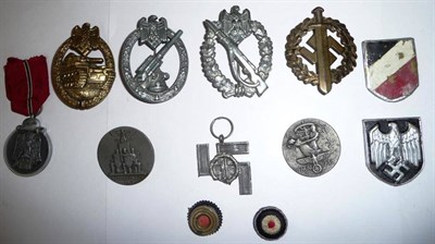 Lot 111 - Seven German Third Reich Badges:- an Infantry Assault badge, silver class; a bronze Tank Battle...