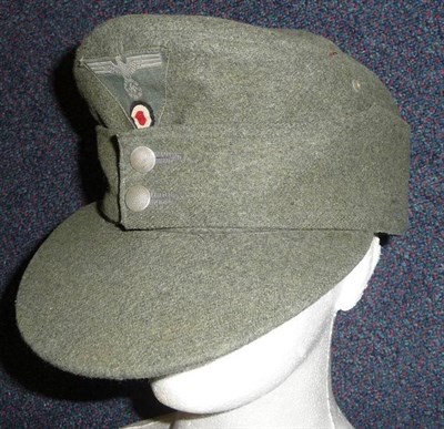 Lot 114 - A German Third Reich EM/NCO's M43 Field Cap, in field grey wool, with woven cap badge, the...