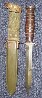 Lot 158 - A US M3 Trench Knife, the crossguard stamped US M3 IMPERIAL, with eight groove leather washer...