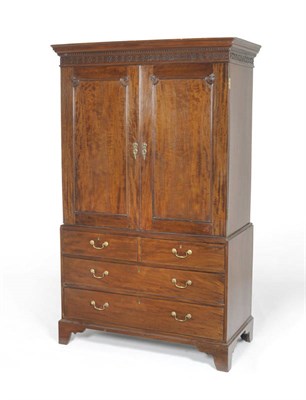 Lot 1533 - A Late George III Mahogany Linen Press, circa 1800, the dentil and blind fret cornice above two...