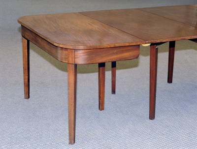 Lot 1534 - A George III Mahogany Dining Table, circa 1800, the two end sections of rounded rectangular...