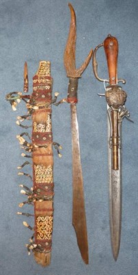 Lot 245 - A Dyak Mandau (Headhunter's Sword), the hatchet tip steel blade with inset brass rivets and...