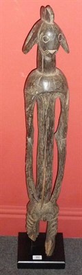 Lot 253 - A Mumuye Carved Wood Ancestor Figure, Nigeria, of abstract form, standing with flared pierced...