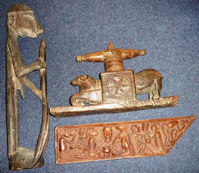 Lot 259 - A Tuareg Carved Wood Food Press, carved as a half kneeling ram, its body with a square block...