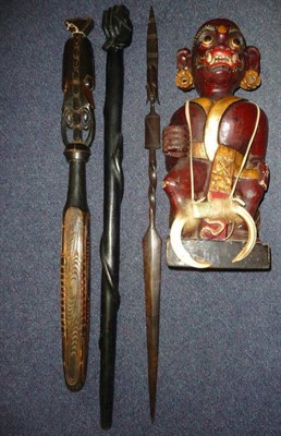 Lot 260 - A Tibetan Lacquered Wood Figure of a Wrathful Deity, seated, wearing a gold painted sash and a...