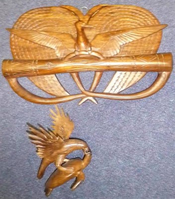 Lot 269 - A Papua New Guinea Emblem Wood Wall Plaque, carved as a bird of paradise perched on a kundu,...