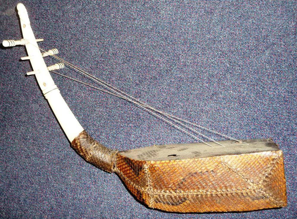 Lot 271 - A West African Four Stringed Instrument, the